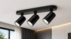 Modern black ceiling light fixture featuring three adjustable lights for versatile illumination