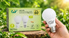 A light bulb placed beside an open box, showcasing its size and shape in a well-lit environment.